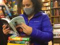 Middle and high-school librarian Cori, looking over some of the ALA award winners 2021 and new arrivals. “This is what happens when you haven’t been to Book Beat in awhile,” said Cori. #readingwomen