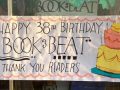Front window sign  by Gabby for Book Beat's 38th birthday